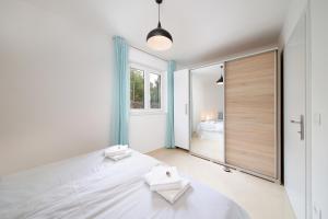 a bedroom with a large white bed and a large mirror at Apartments Via Sole Dramalj in Dramalj