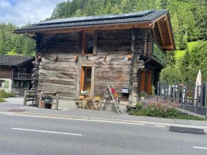 a wooden cabin on the side of a road at Raccard rénové in Orsières