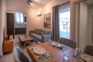 a living room with a table and a couch at Katia Athens Apartment in Athens