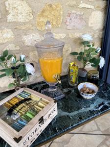 a table with a box of chopsticks and a glass of orange juice at Les Hauts de Courrech in Grézels +7 photos