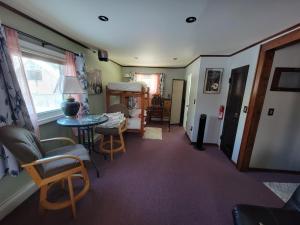 a hallway with a room with a table and chairs at Billie's Backpackers Hostel in Fairbanks
