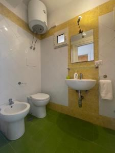 a bathroom with a toilet and a sink at Medioevo Mare in Pisciotta