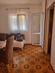 a living room with a couch and a window at Summer rental house "Kava" in Okrug Donji