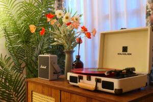 a table with a radio and a vase with flowers at Stay EROB in Seoul