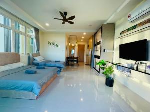 a living room with a couch and a ceiling fan at Kuching City Center Riverine Apartment With Balcony and Marvelous View in Kuching