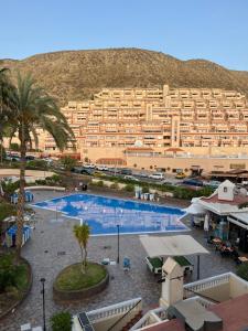 un grand hôtel avec une grande piscine devant un immeuble dans l'établissement Jolana apartment Los Cristianos, à Los Cristianos