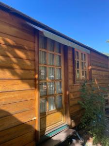 a wooden cabin with windows on the side of it at la roulotte chez Camille in Veynes