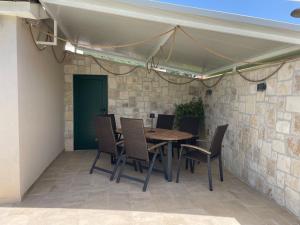a table and chairs under a tent on a patio at Villa Dupini in Baška