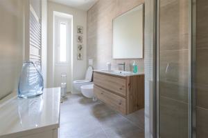 a bathroom with a sink and a toilet at IseoLakeRental - Fantasy Lake in Castro +13 photos