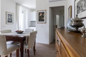 a kitchen with a wooden table and a dining room at IseoLakeRental - Fantasy Lake in Castro