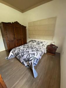 a bedroom with a bed with a zebra blanket and a dresser at Casa Bizzacchi Pinhal in Espirito Santo Do Pinhal