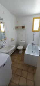 a bathroom with a tub and a toilet and a sink at Maison Hortensias Fromentine 8 pers près de la plage in La Barre-de-Monts +10 photos