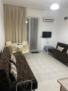 a living room with a couch and a table at Mermaid in Marmaris