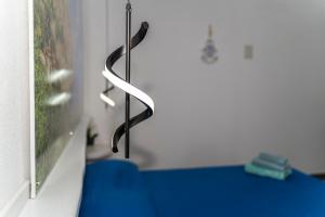a black metal object hanging from a wall at Apposentos in via Baus in Santa Maria Navarrese