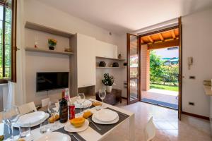 a dining room with a table with wine glasses at Villa Baccolo in Manerba del Garda