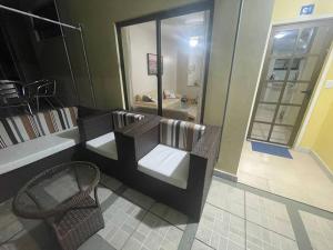 a room with a couch and a chair in a store at Casa 3 qtos beira mar praia exclusiva e piscina in Angra dos Reis