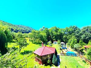 an aerial view of a small house on a hill at Vila Mikdonia - Predelut Home in Predeluţ +11 photos