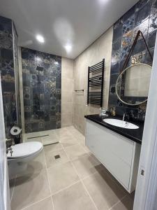 トビリシにあるTeas modern placeの洗面台、トイレ、鏡のあるバスルーム