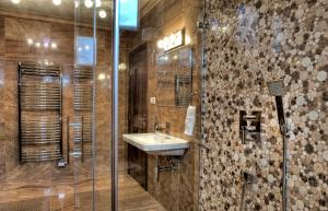 a bathroom with a sink and a shower at Mountain Resort Ždiar - Chalets in Ždiar