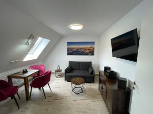a living room with a couch and a table at Auszeit in Zeltingen-Rachtig