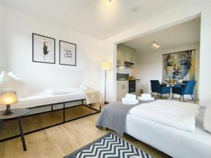 a room with two beds and a table and chairs at Bright Apartment für bis zu 5 Erlangen in Erlangen