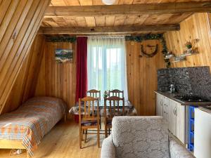 a bedroom with a bed and a table in a room at The Cottage in the Mountains in Gomi