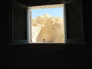 an open window with a view of a desert view at Lotus House in siwa oasis