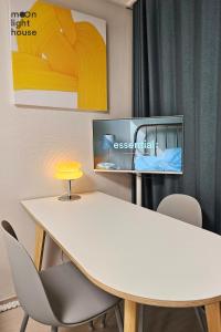 a meeting room with a white table and chairs at Moonlight Sokcho - High-rise, Ocean and City View in Sokcho