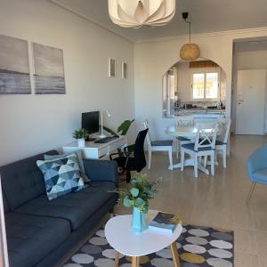 a living room with a couch and a dining room at Ático Calblanque in Mar de Cristal