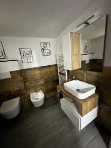 a bathroom with a sink and a toilet at Umbertos Rooms in Jerzu +95 photos