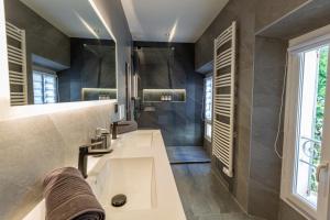 a bathroom with a sink and a mirror at L'Oranger T4 Elegant and bright Prime Location in Grasse +39 photos