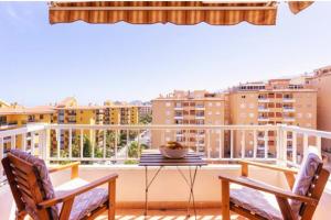 a balcony with a table and chairs and a view of buildings at Ocean Sky in Candelaria