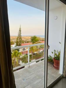 a room with a view of the ocean from a balcony at Albertina Suites in El Yaque