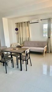 a living room with a table and chairs and a couch at Albertina Suites in El Yaque