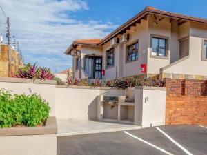 a house with a parking lot in front of it at 31 on Windsor Guest House in Durban