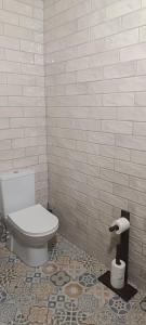 een badkamer met een toilet en een tegelwand bij Trabzon Tosun Bungalov in Trabzon