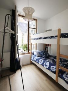 a bedroom with two bunk beds and a window at Ti Melen in Morlaix