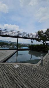 a bridge over a pool of water with a bridge over it at Urban 360 Batu Caves Sri Gombak Selayang Wifi Netflix by N&N in Batu Caves +4 photos