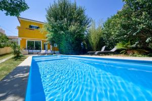 a swimming pool in front of a house at Beach & Nature Villa with Amazing Pool by TimeCooler in Setúbal