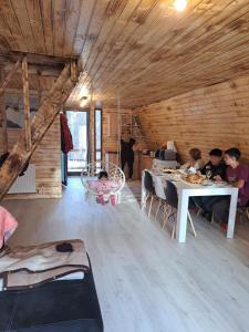 a group of people sitting in a room with a table at CabanaAframe in Curtea de Argeş
