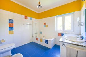 a bathroom with a sink and a tub and a toilet at Beach & Nature Villa with Amazing Pool by TimeCooler in Setúbal