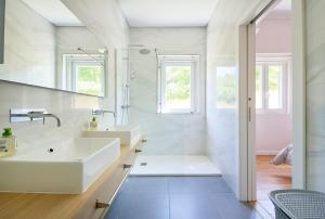 a white bathroom with a sink and a shower at Beach & Nature Villa with Amazing Pool by TimeCooler in Setúbal
