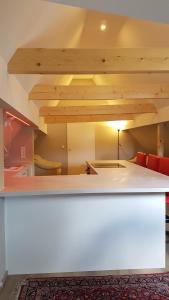 a white counter in a room with a ceiling at Neue wunderschöne Ferienwohnung direkt im Herzen von Rockenhausen in Rockenhausen