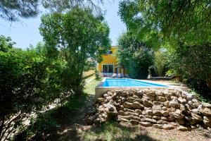 a pool in front of a house with trees at Beach & Nature Villa with Amazing Pool by TimeCooler in Setúbal