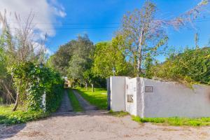 an entrance to a house with a wall and a driveway at Beach & Nature Villa with Amazing Pool by TimeCooler in Setúbal