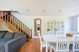 a living room with a couch and a table at Beach & Nature Villa with Amazing Pool by TimeCooler in Setúbal