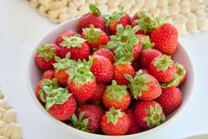 a bowl of strawberries sitting on a table at Beach & Nature Villa with Amazing Pool by TimeCooler in Setúbal