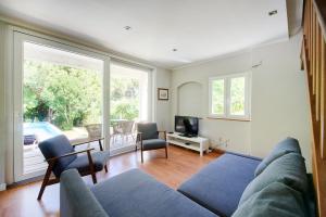 a living room with a couch and a tv at Beach & Nature Villa with Amazing Pool by TimeCooler in Setúbal