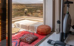 a room with a window with a view of a city at tayyurt surf Maroc in Agadir