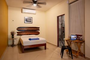 a bedroom with a bed and a laptop on a table at Puerto Dreams H in Puerto Escondido